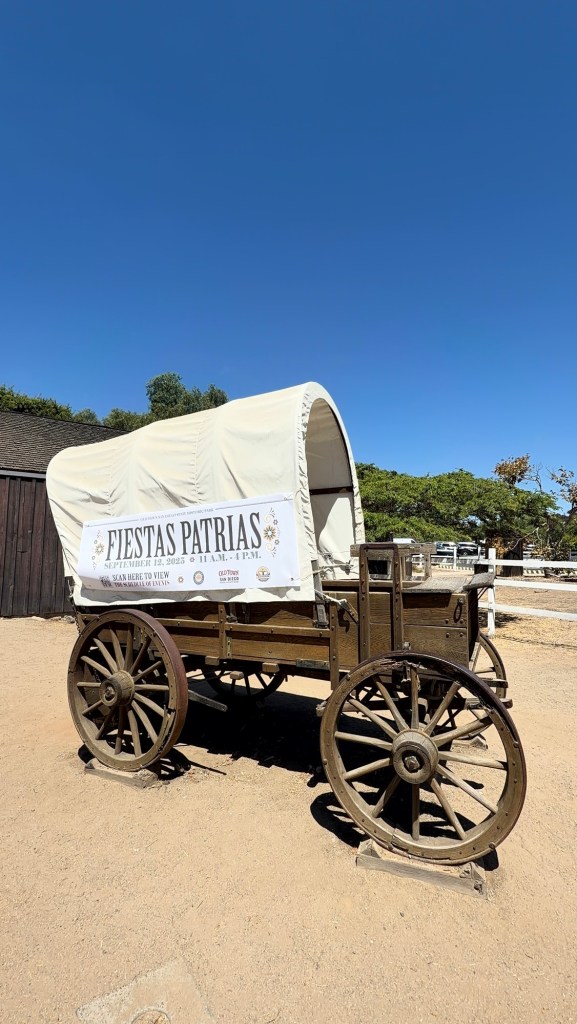 Child climbing on the covered wagon in Old Town San Diego